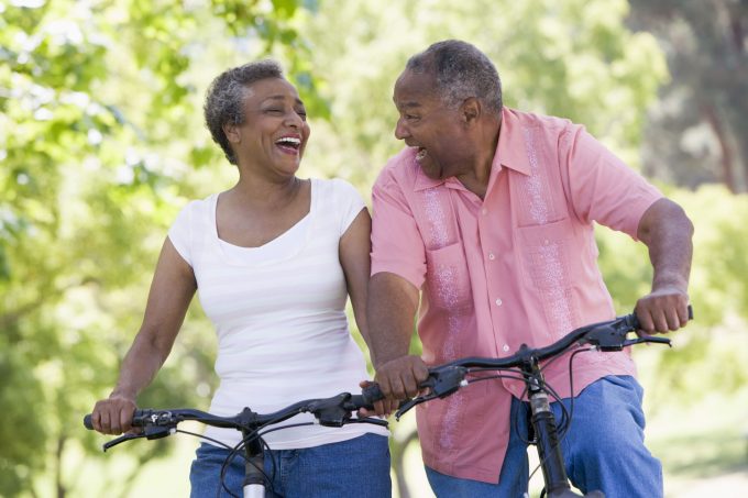 active elderly couple on bicycles